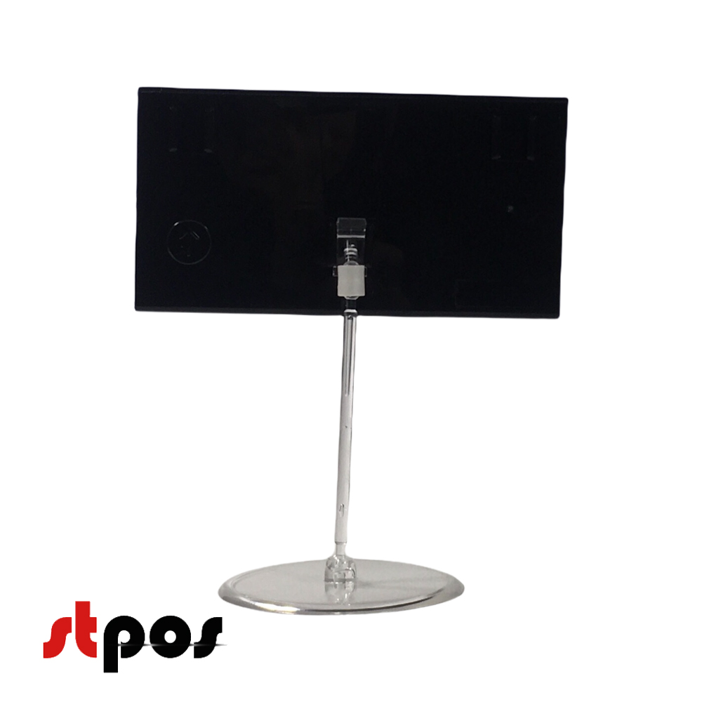 07 кассета цен формата A7L в прозрачном держателе на прозрачной круглой ножке. Цвет кассеты — чёрный. На фото кассета в держателе, расположенная вертикально. Ракурс съёмки — вид сзади..